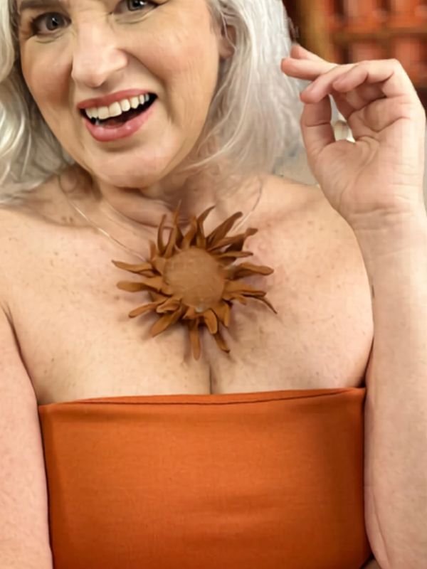 Detalhe de um jardim de girassóis e peça em cerâmica em estilo editorial refinado